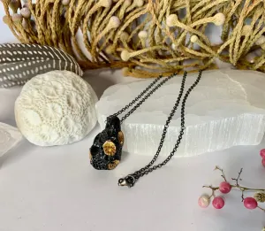 Black ‘rock coral’ pod pendant on oxidised sterling silver chain.